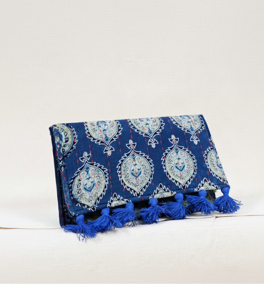 Blue patterned clutch with tassels on a white background