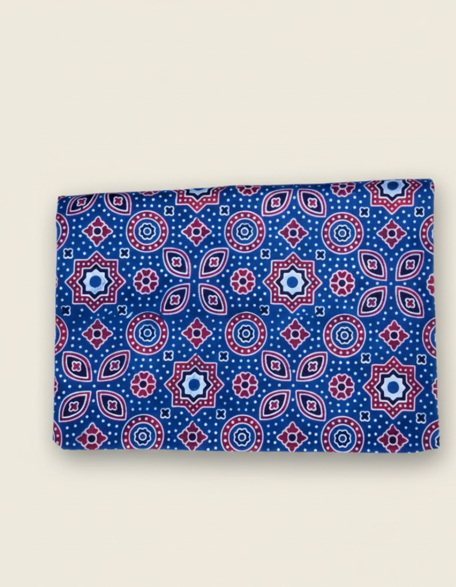 blue ajrakh saree fabric with geometric patterns on a beige background