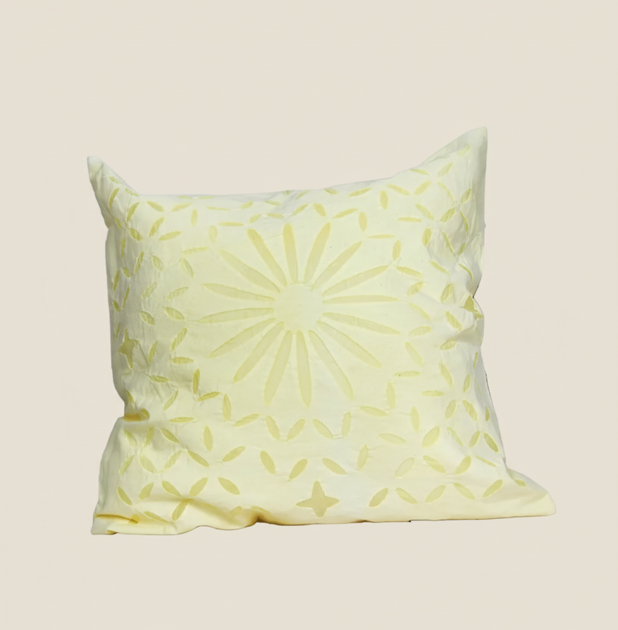 Yellow patterned pillow on a beige background