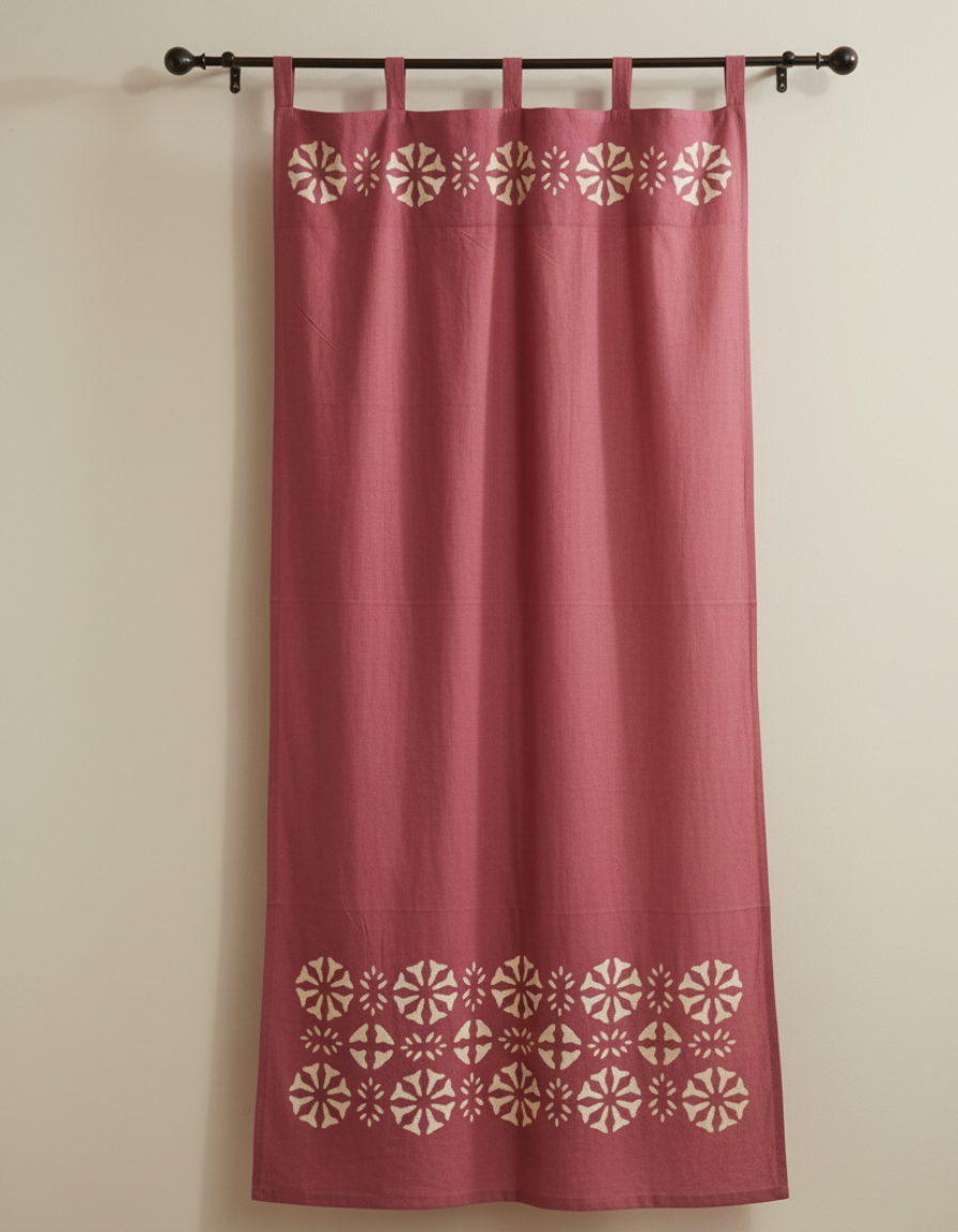 Red curtain with white geometric patterns on a beige wall