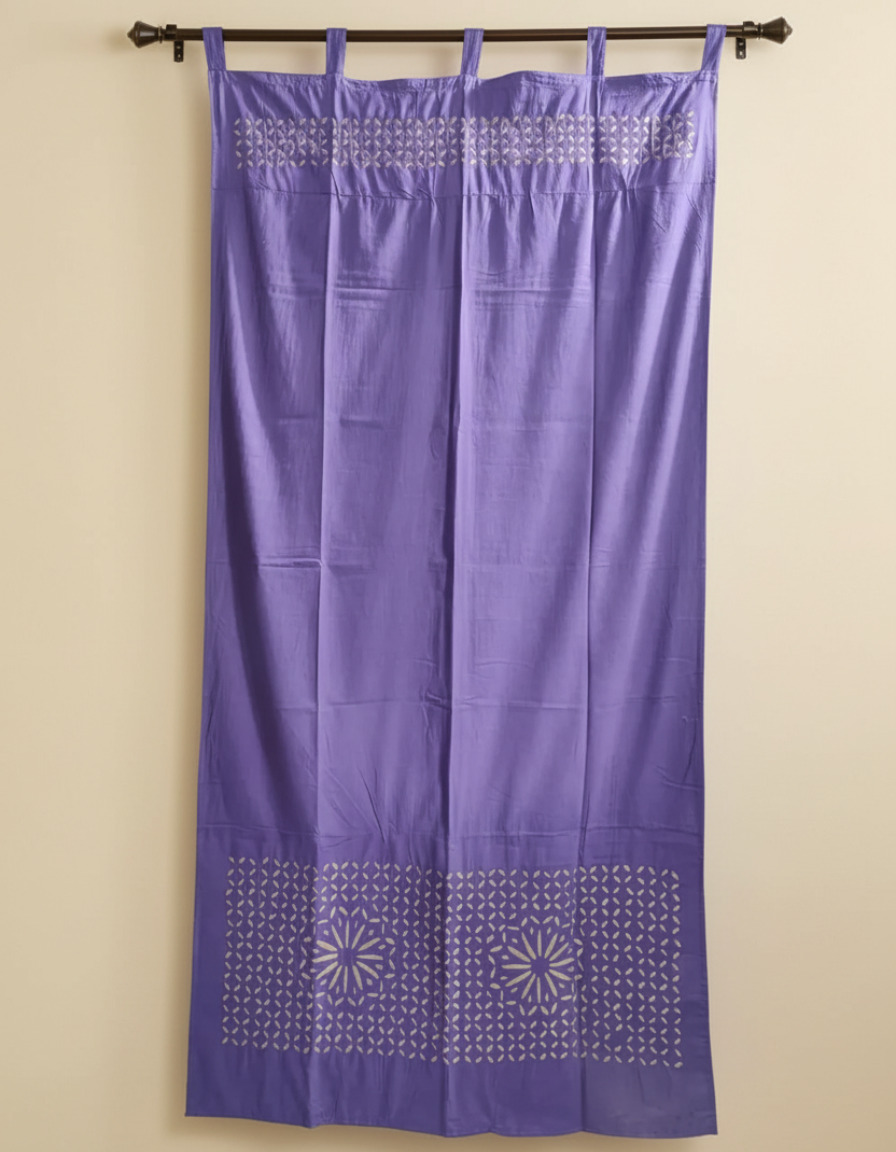 Purple curtain with decorative patterns on a beige wall