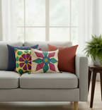 Gray sofa with colorful patterned applique cushions in a bright living room.