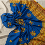 Blue fabric with yellow and red floral patterns on a white background