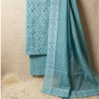 Teal fabric with intricate white lace detailing on a beige background