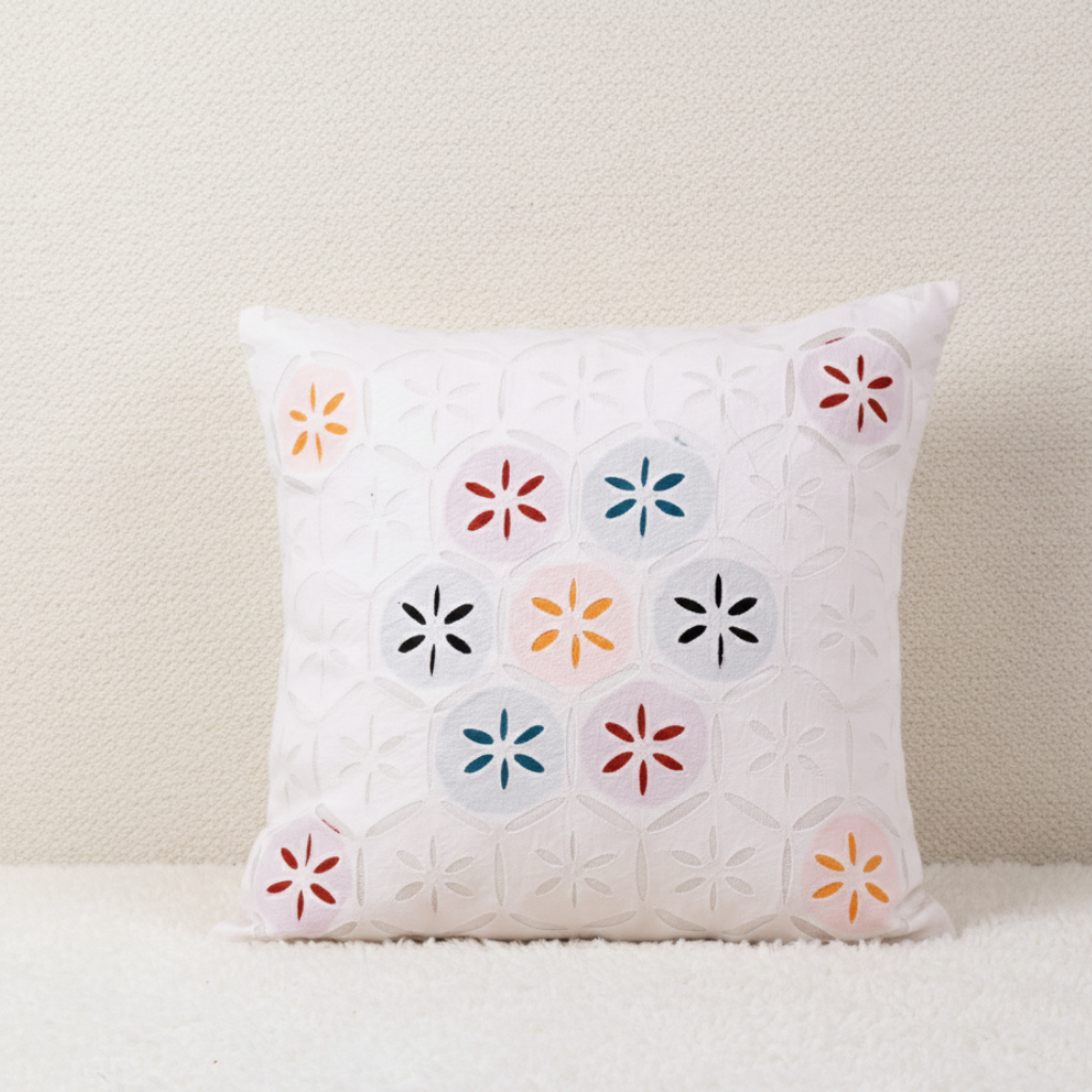 applique cushion cover with colorful geometric cutwork pattern on a neutral background