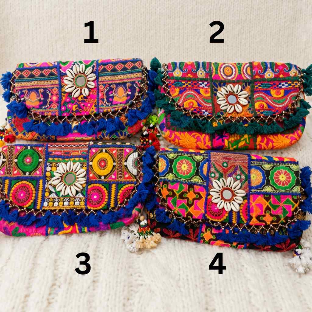 Colorful embroidered boho bags with floral patterns on a textured surface