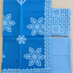 Set of blue applique fabric pieces with floral and geometric patterns 