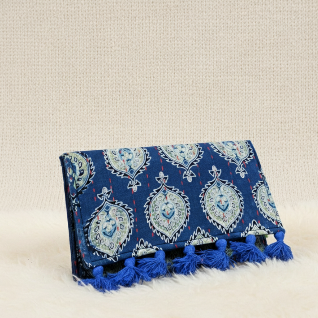 Blue patterned clutch with tassels on a beige background