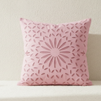 Pink applique cushion cover with a sunburst pattern on a neutral background