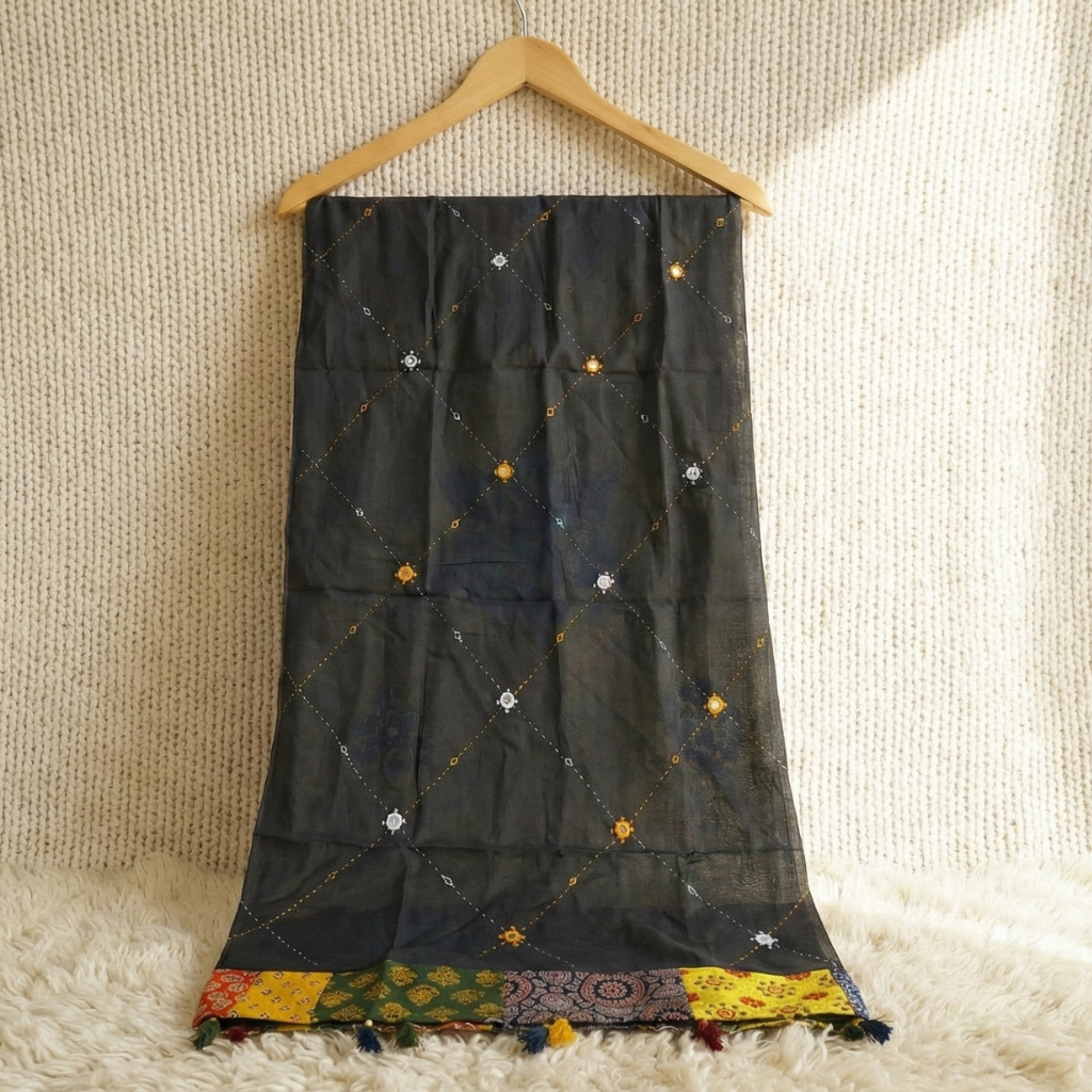 Black embroidered dupatta on a wooden hanger against a textured beige background
