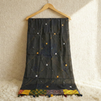 Black embroidered dupatta on a wooden hanger against a textured beige background