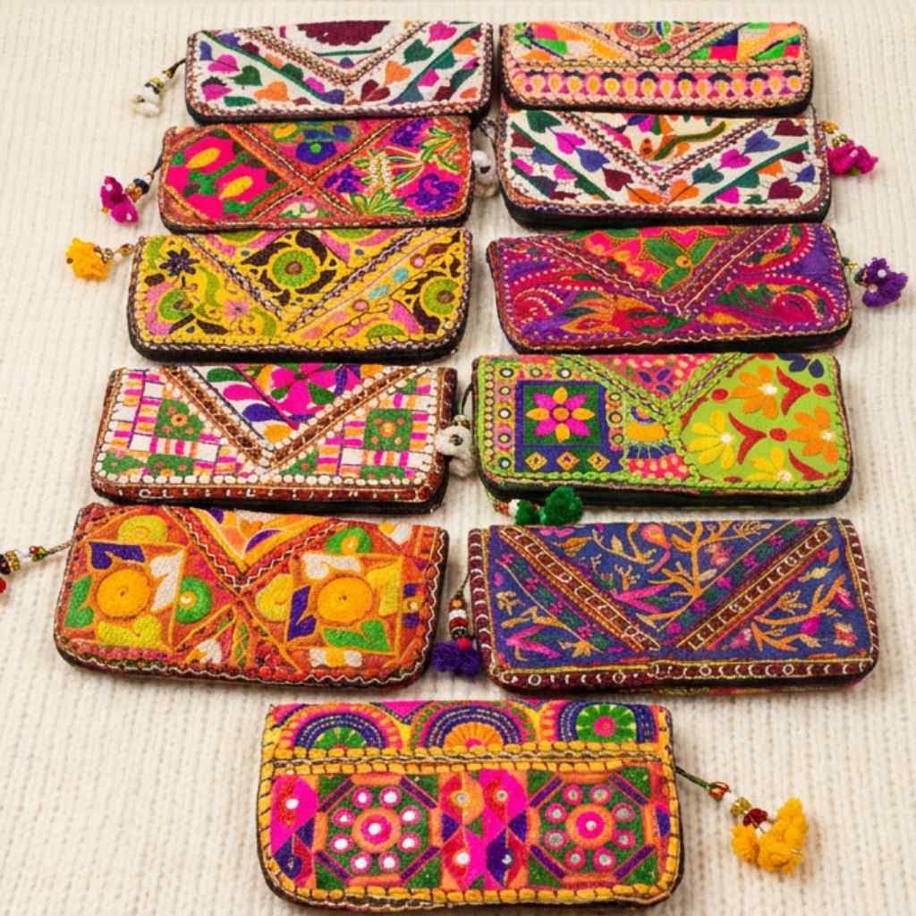 Collection of colorful embroidered clutches on a light background
