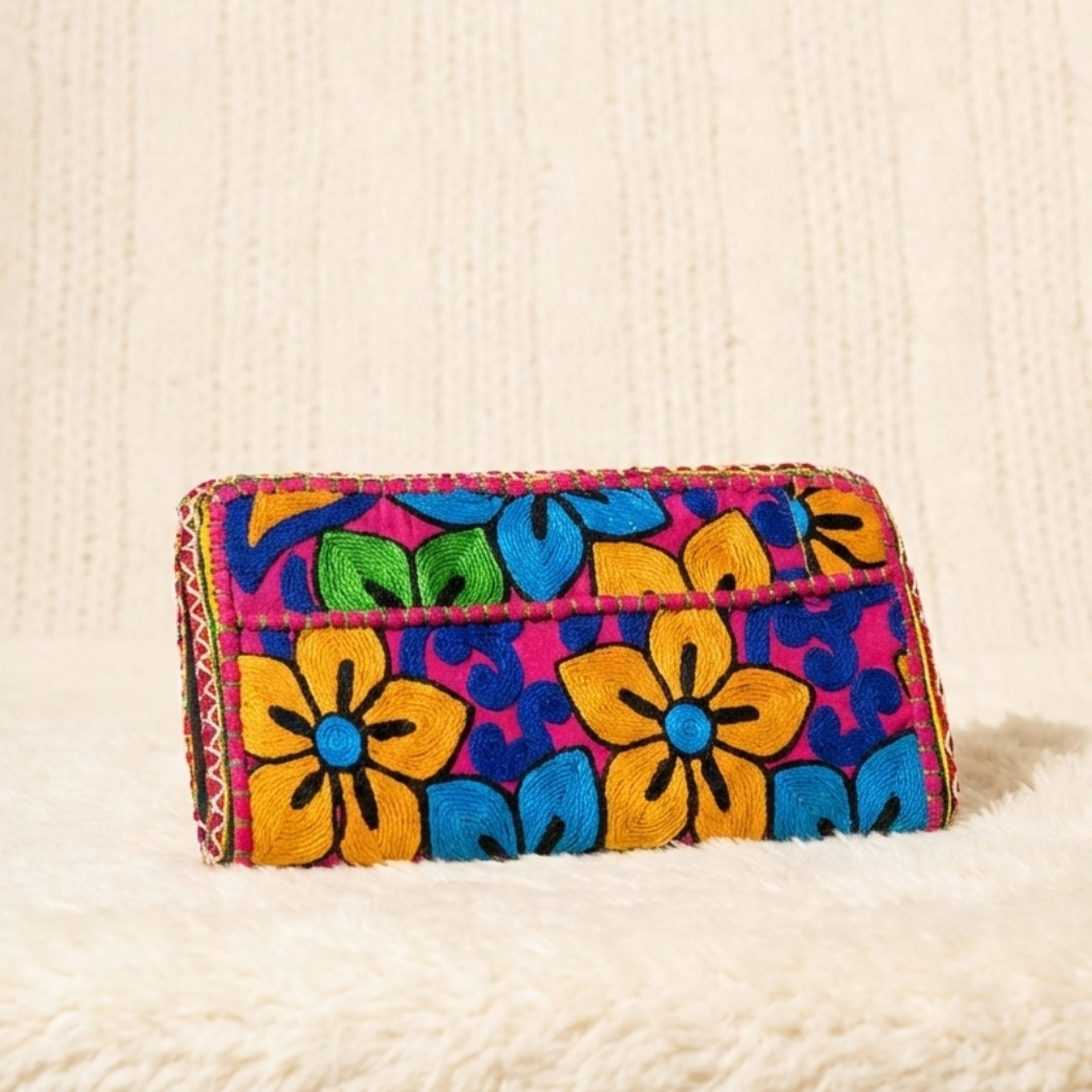 Colorful floral-patterned wallet on a textured surface