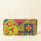 Colorful embroidered wallet on a textured white background