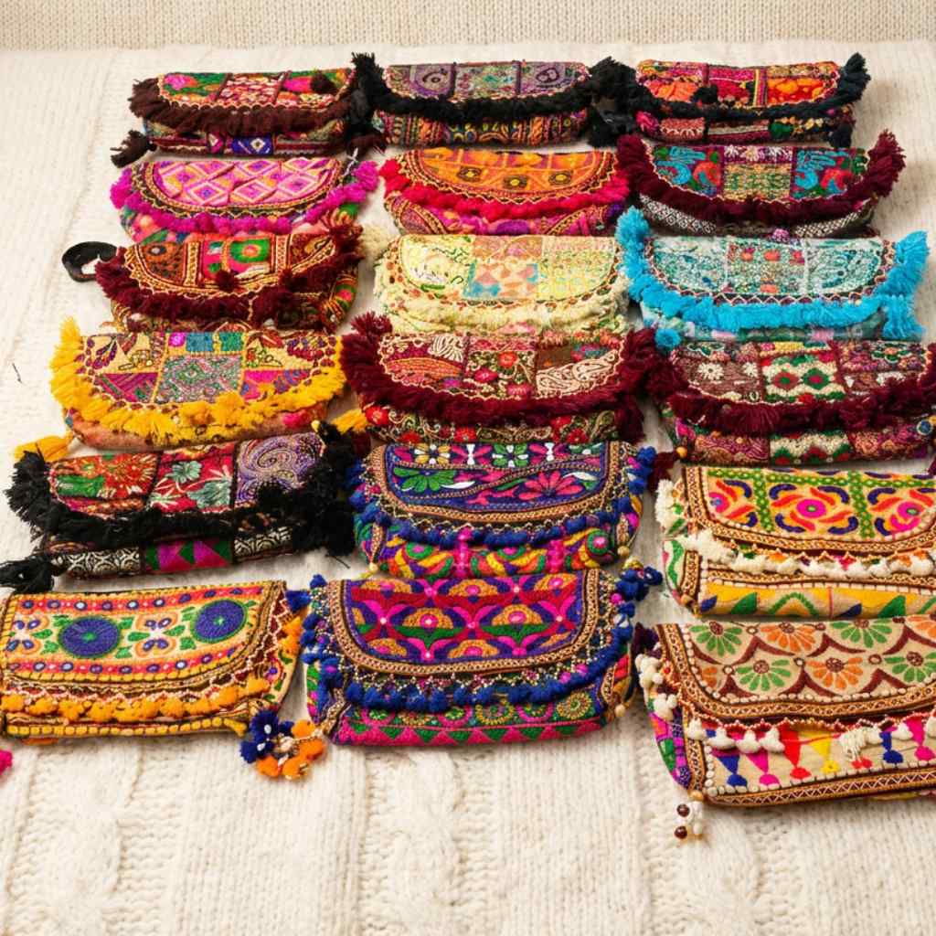 Collection of colorful embroidered handbags on a light background