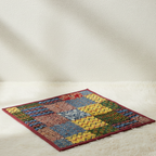 Colorful woven mat on a beige surface