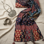 Decorative dupatta with intricate patterns and silver jewelry on a light fabric background