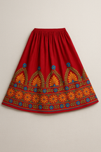 Red skirt with colorful embroidery on a beige background