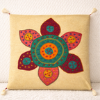 Decorative cushion cover with a colorful floral pattern on a beige background
