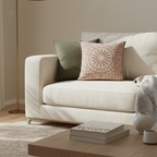 Beige sofa with decorative pillows in a living room setting