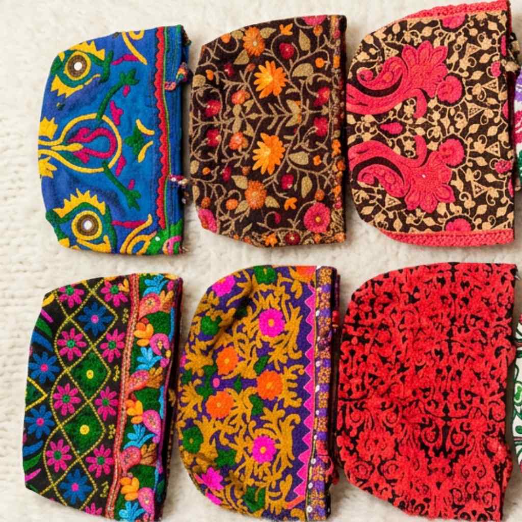 Set of colorful embroideredbags on a textured surface