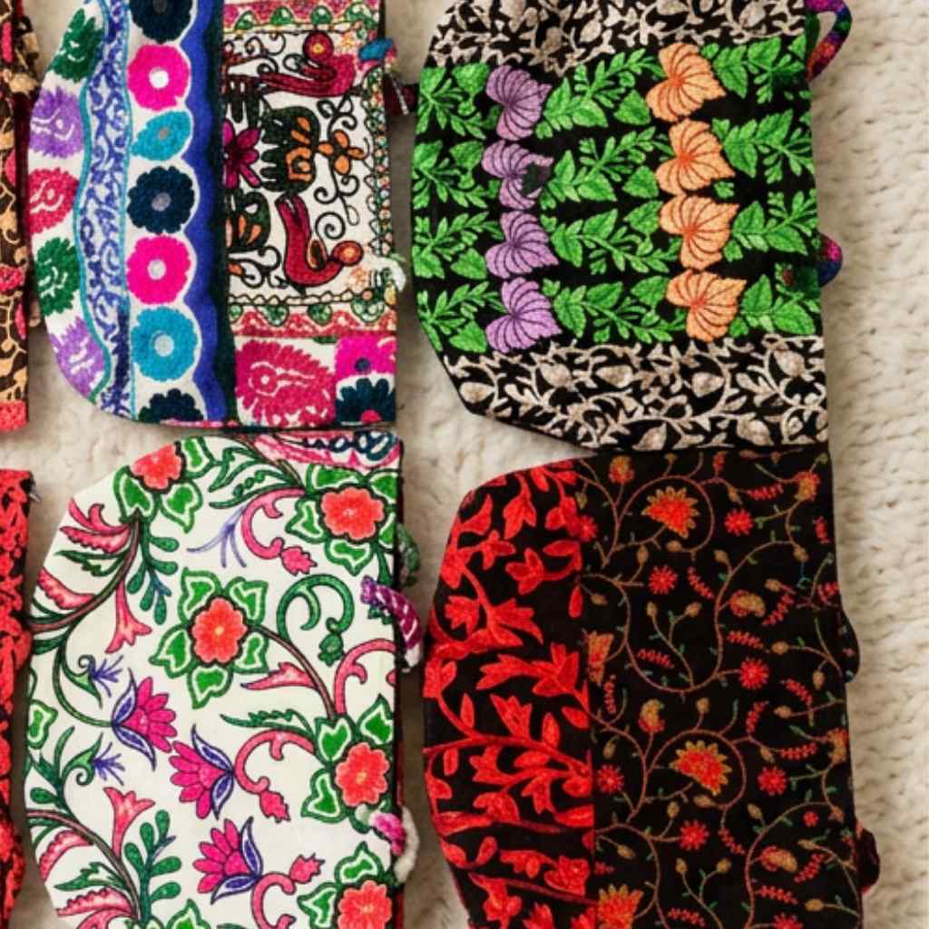 Collection of colorful embroidered bags on a textured surface