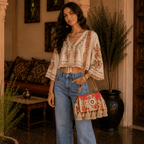 a girl in a ethnic top and jeans carrying an embroiderd banjara bag