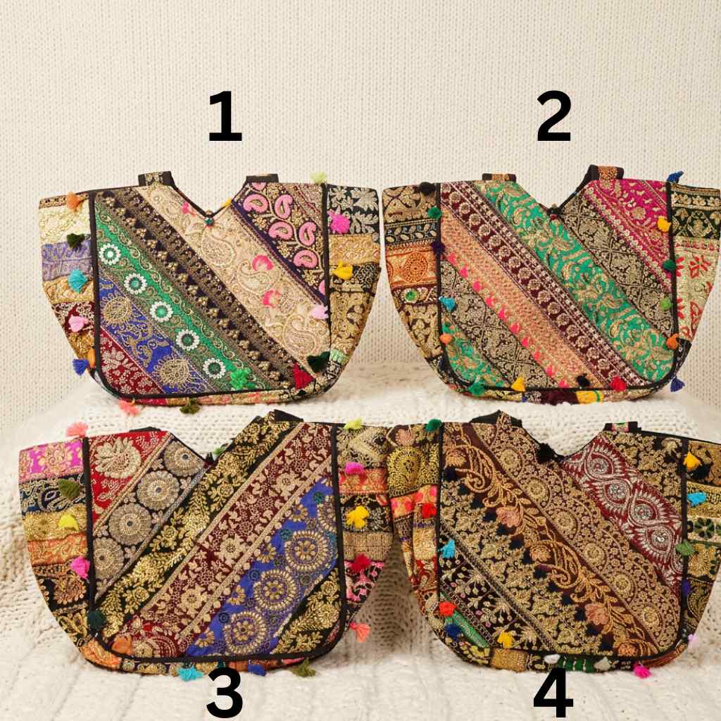 Four colorful embroidered zari bags with patterns and pom-poms on a textured beige background.