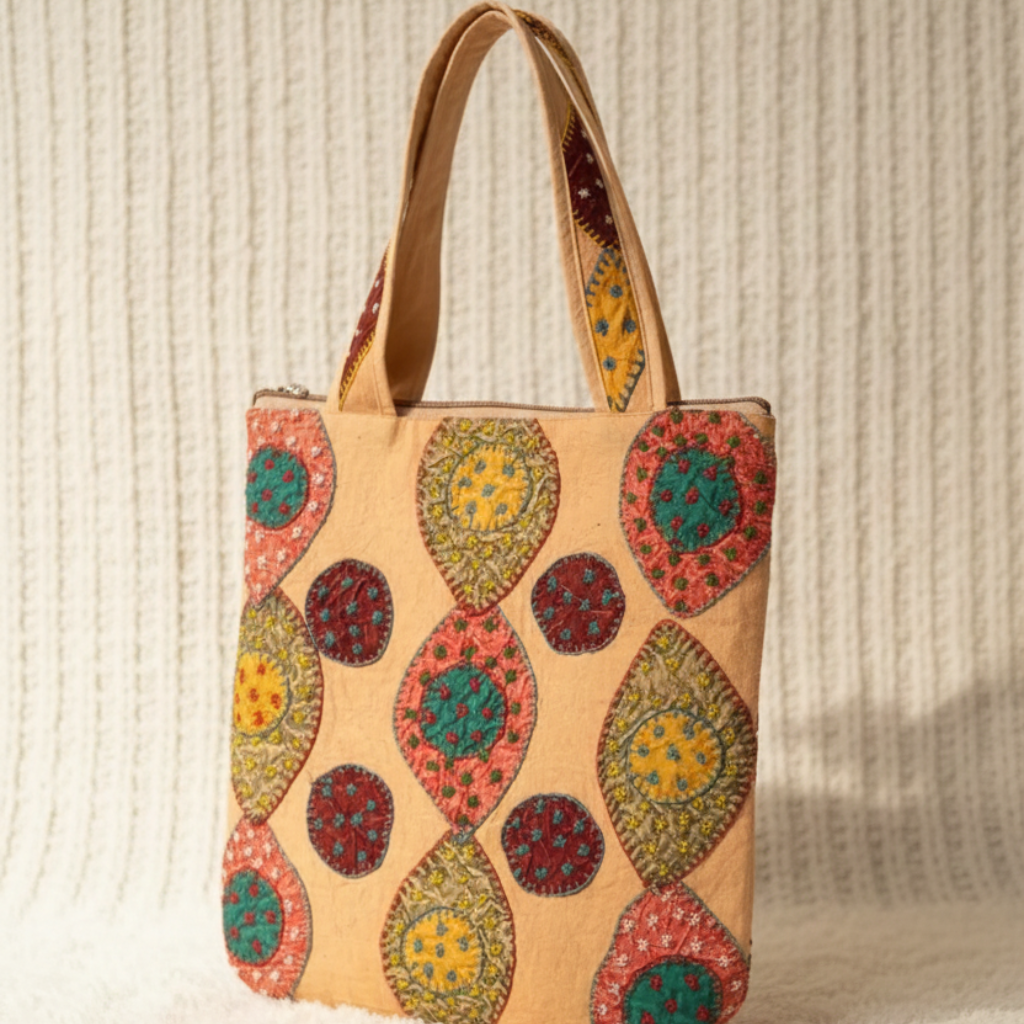 Tote bag with colorful circular patterns on a textured beige background