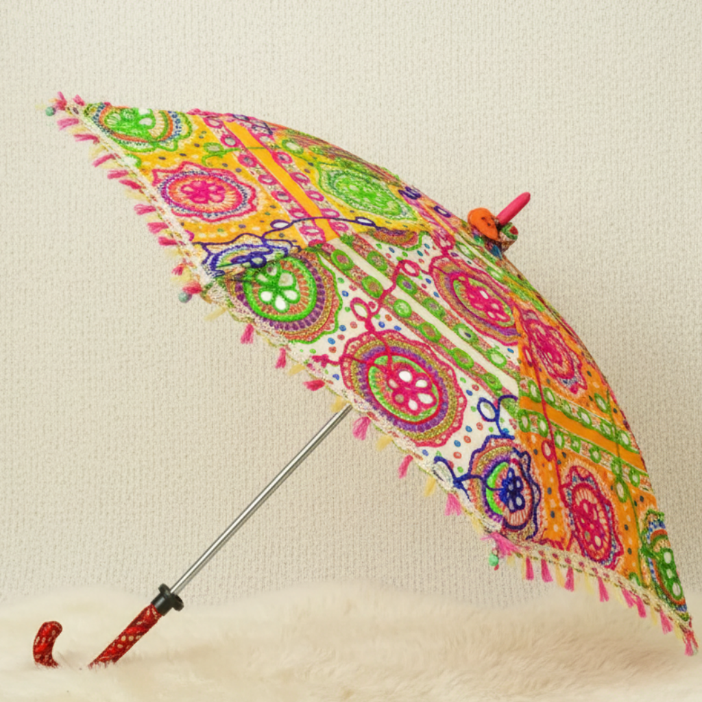 Colorful patterned umbrella with tassels on a beige background