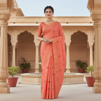 Woman in a coral saree standing in front of an architectural background