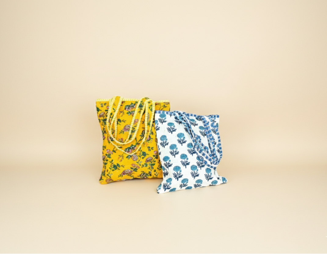 Two fabric bags with floral patterns on a beige background