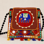 Colorful embroidered red sling bag with an elephant design on a beige background