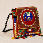 side view of colorful red embroidered elephant sling bag