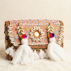 Colorful pastel banjara handbag with decorative elements on a light background
