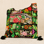 Colorful green embroidered bag with floral patterns on a beige background