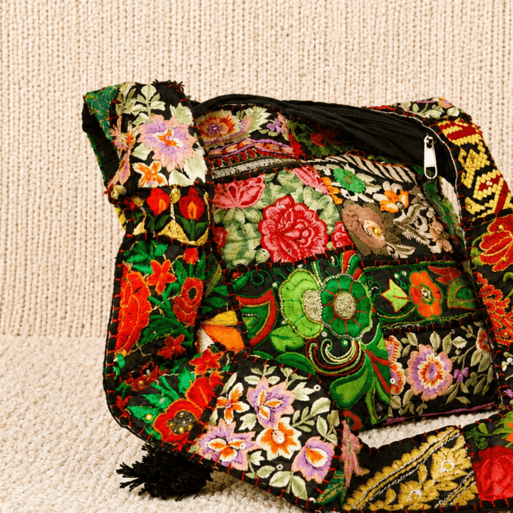 Colorful embroidered bag on a beige textured surface
