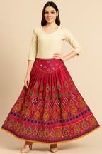 Woman wearing a fuchsia pink hand embroidered skirt with a beige top 