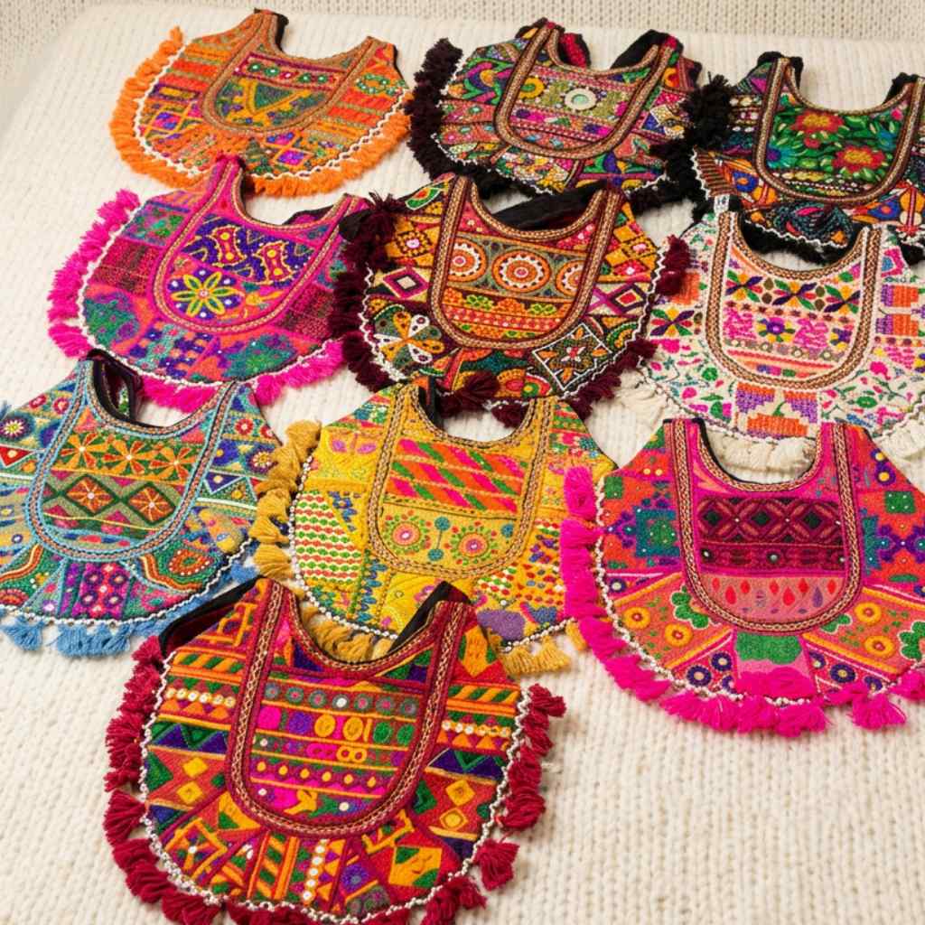 Colorful embroidered bags with intricate patterns on a textured surface