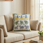 Decorative pillow with colorful patterns on a beige sofa in a bright room.