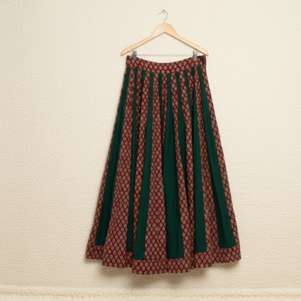 Long patterned skirt on a hanger against a beige wall