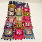 Colorful ajrakh bags with numbers on a beige background