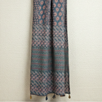 blue ajrakh dupatta with tassels on a textured white background