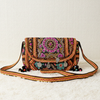 Embroidered handbag with colorful patterns on a light background