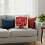 red tree applique work on white cushion cover laced on a sofa in a room setting