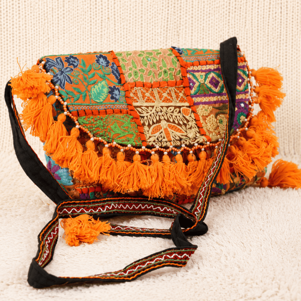 an orange Nomad Banjara Embroidered Sling Purse