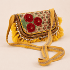 a yellow Nomad Banjara Embroidered Sling Purse