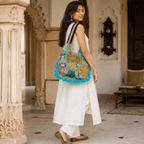 woman in a white kurta set with a Pastel Blue Zari Embroidered Tote Bag 