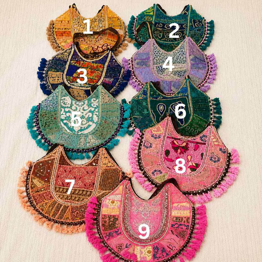 Colorful embroidered fabric zari bags with numbers on a beige background