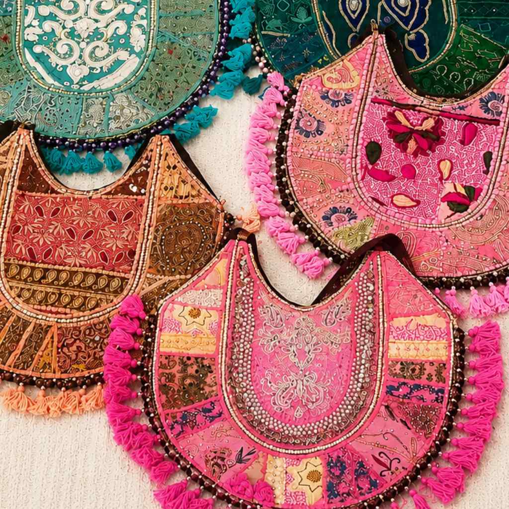 Colorful embroidered zari bags with tassels on a light background